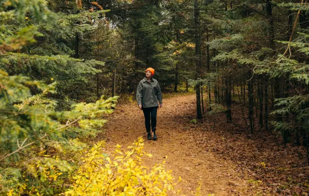 A woman walking in a forest.