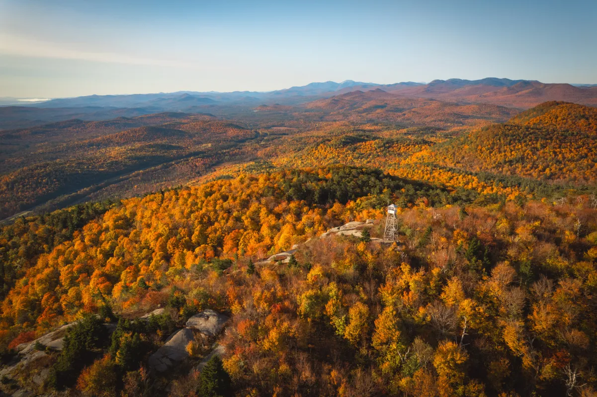 A mountain range covered in fall foliage.