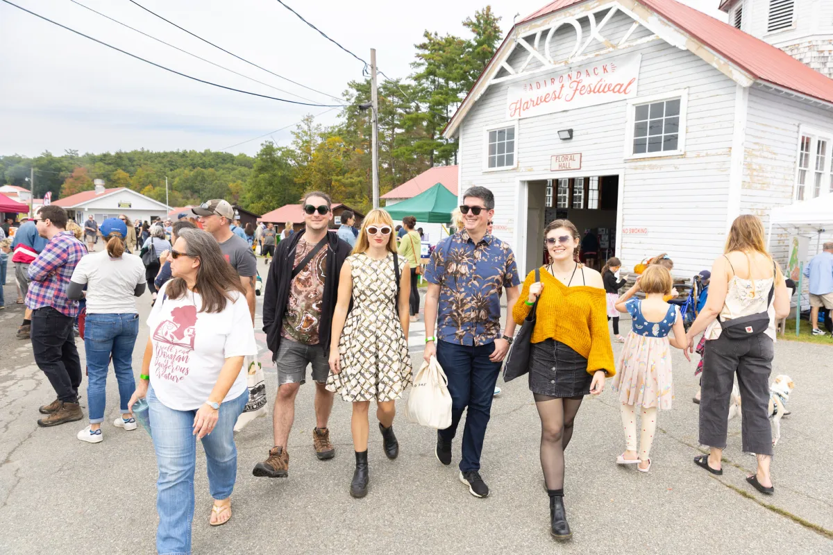 A group of people walk at a harvest festival.