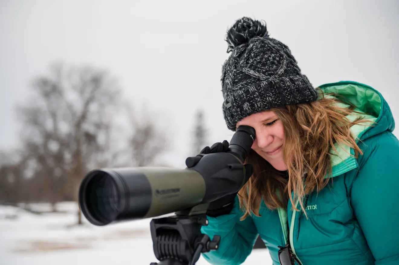 woman looking through for birds