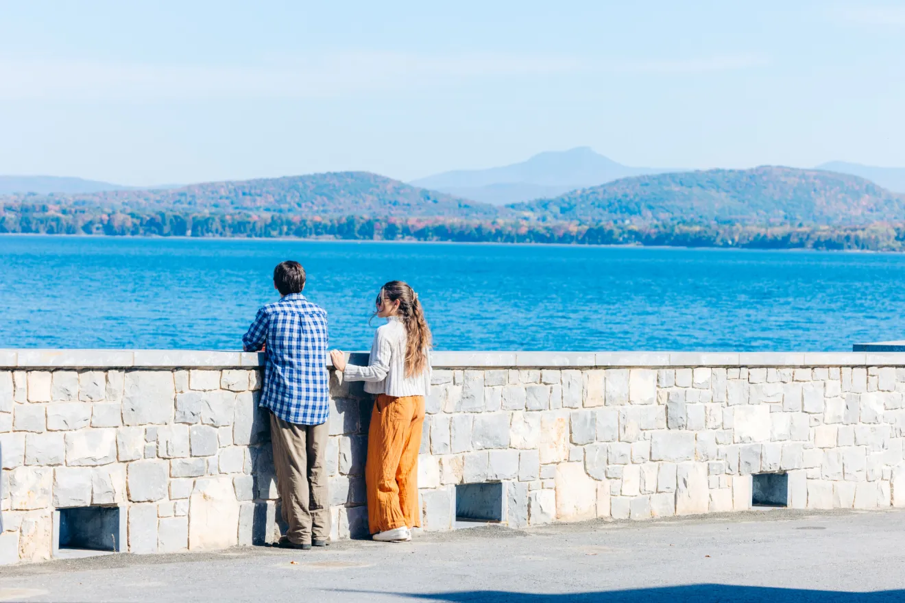 people standing out and looking at the lake