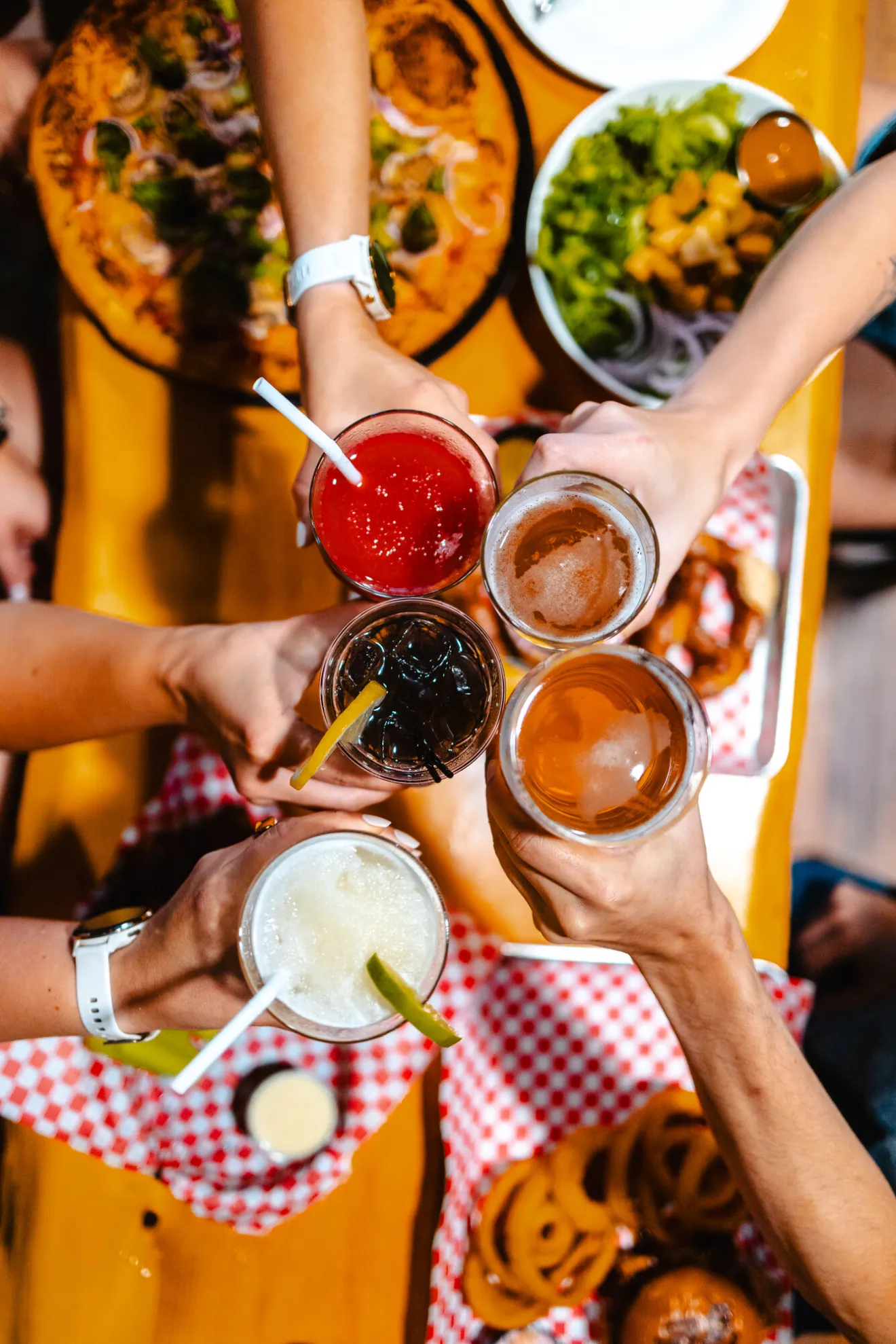 A group of friends cheers drinks at a brewery.