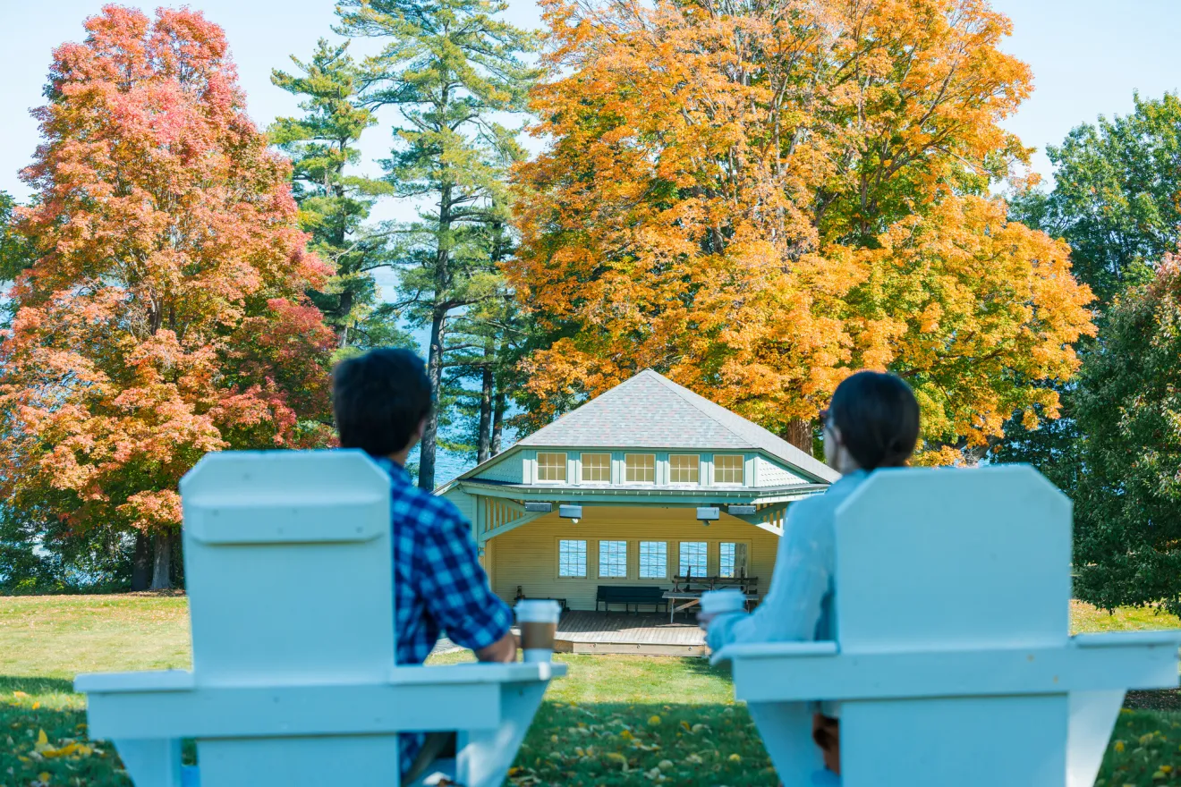 a couple sitting looking out at the foliage