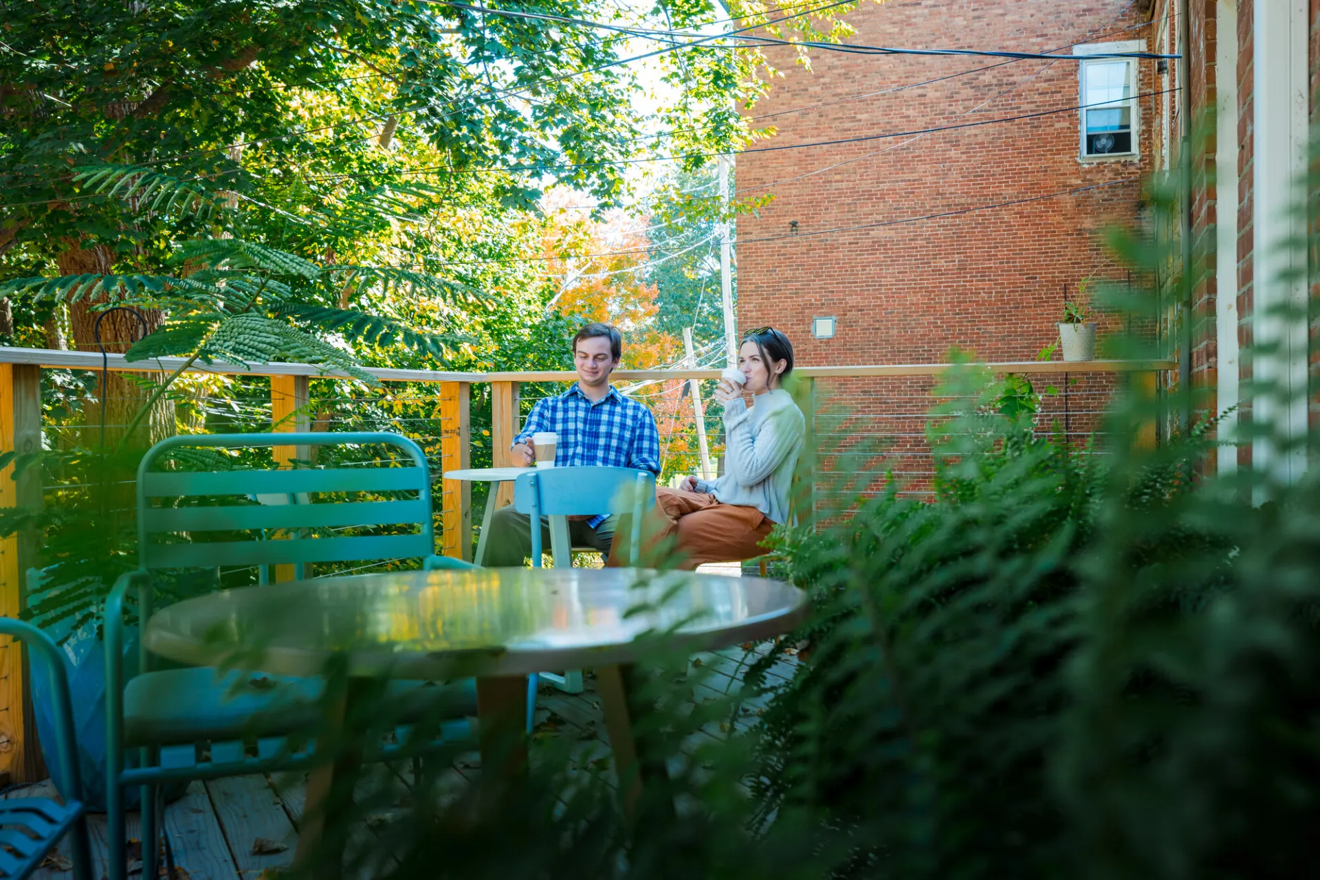 A couple drinking coffee in the summer.