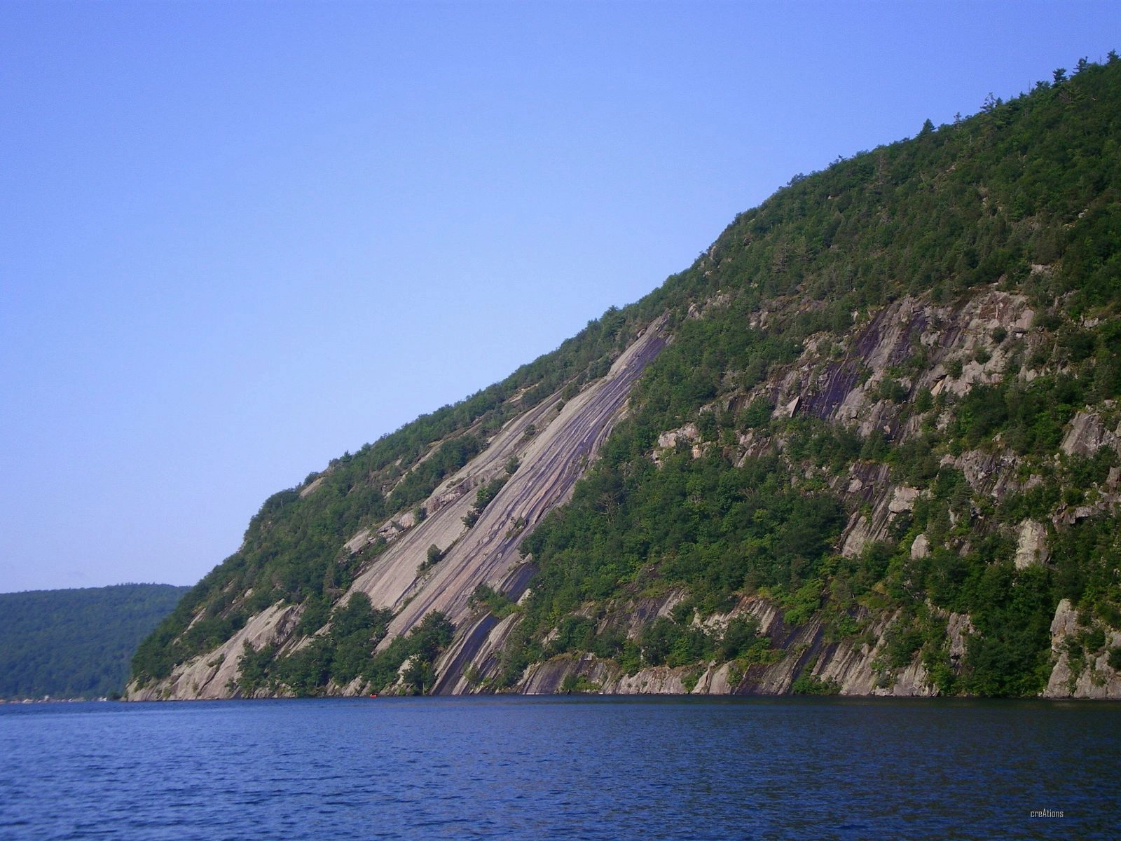 A lake with a mountain next to it. 