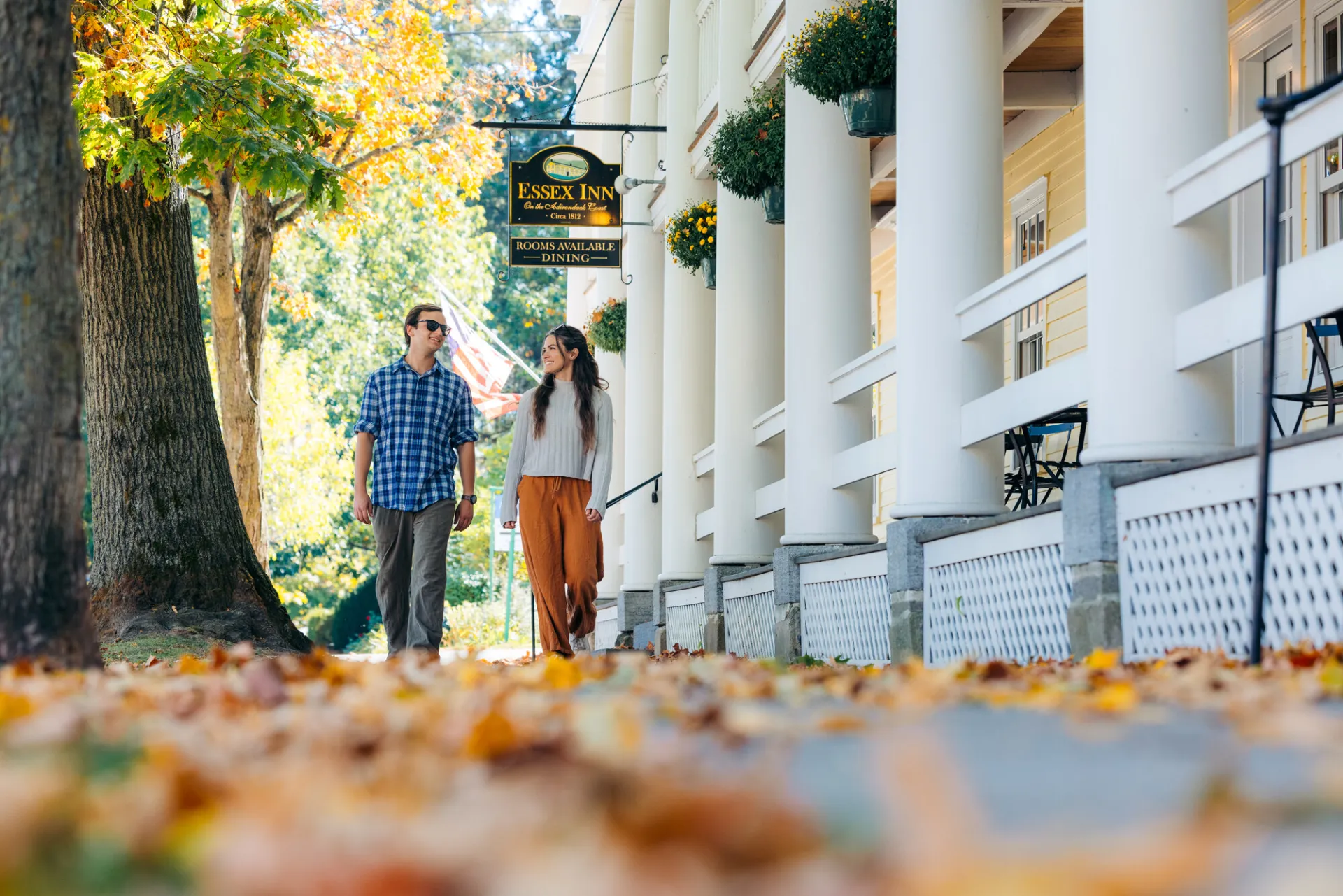 A couple walking on a fall street.