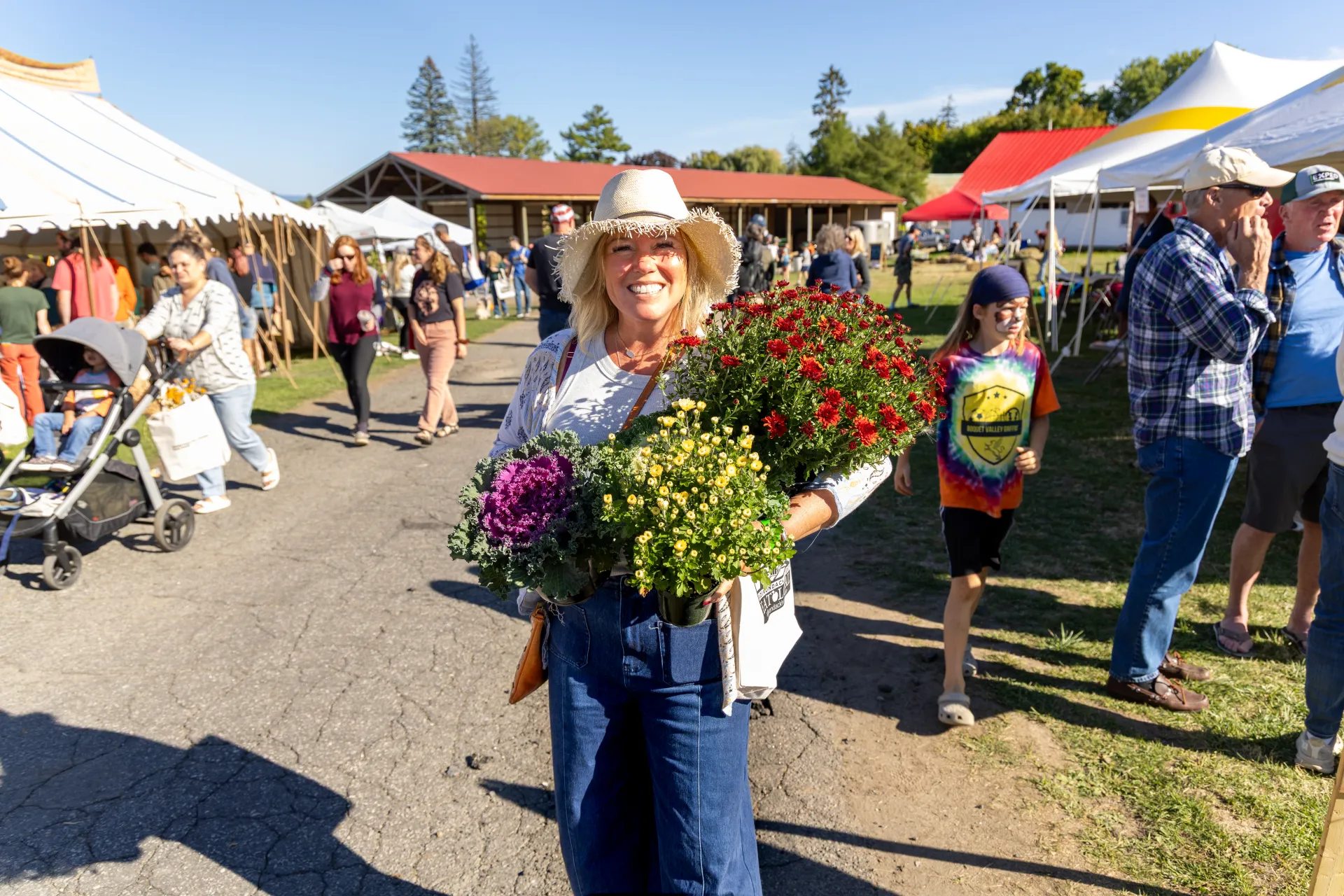woman holding flowers from the harvest festival in westport