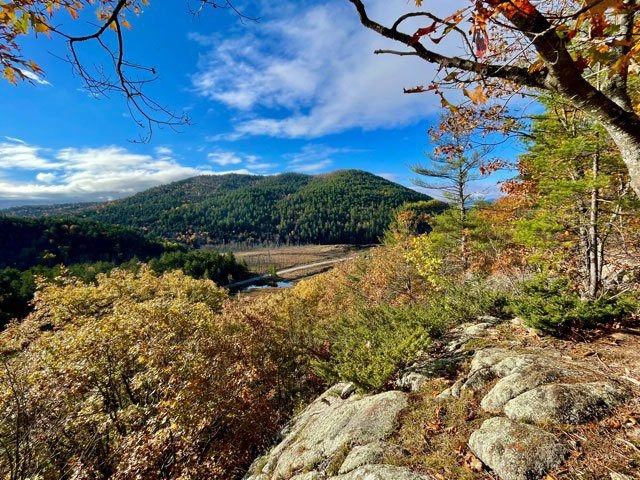 A scenic view of a small ponds and mountains
