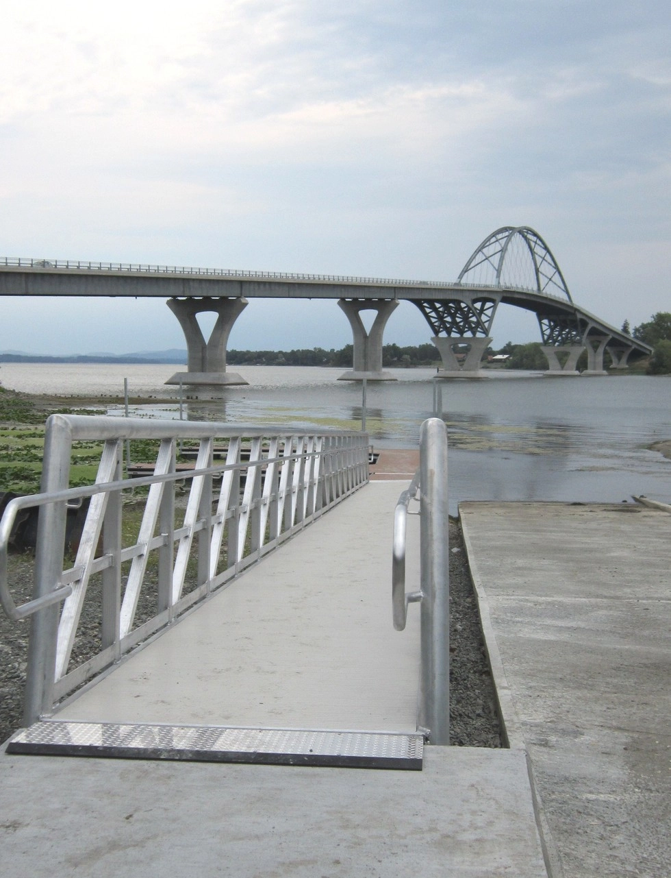 A boat launch in the shadow of a bridge