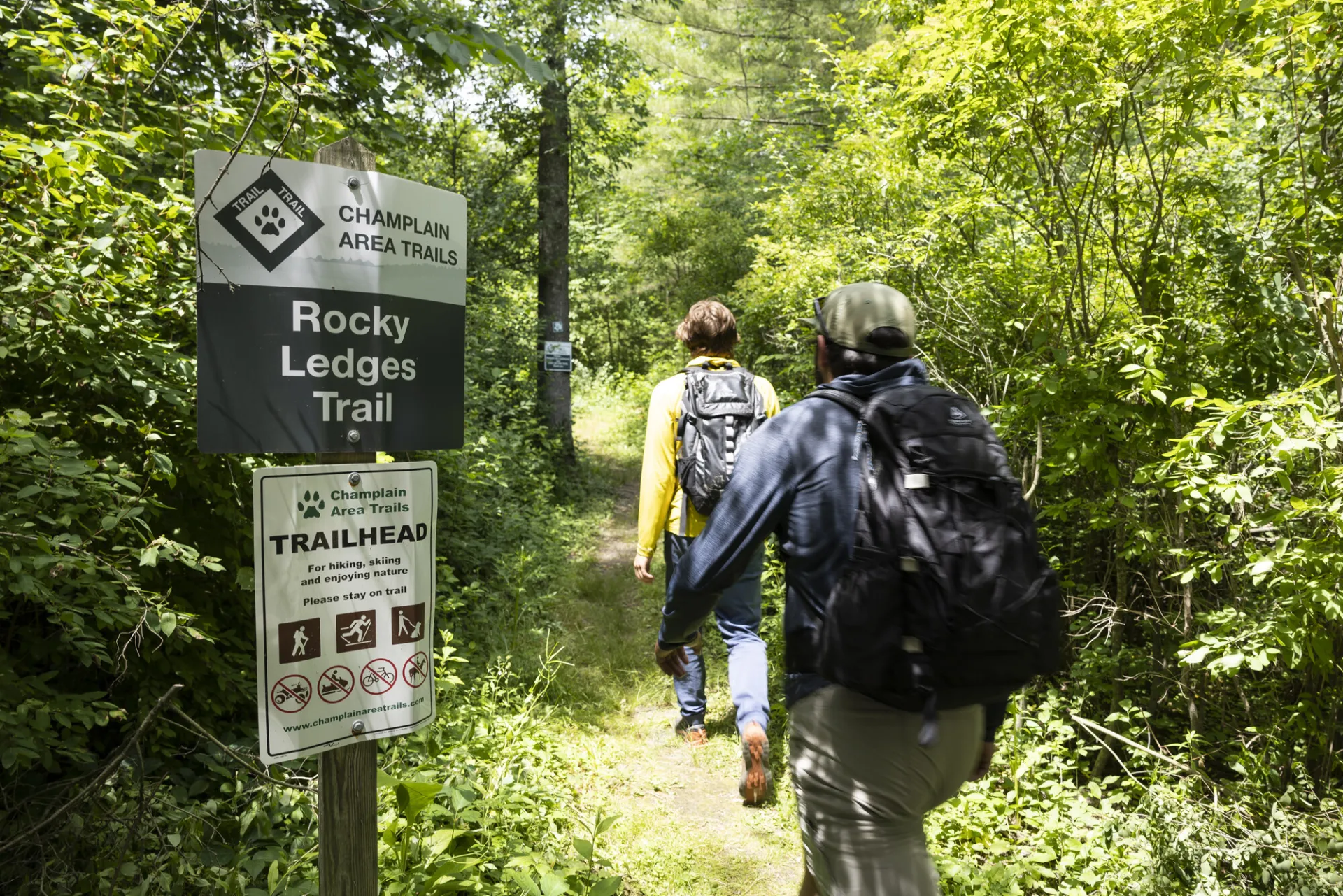 Two hikers head out onto the Rocky Ledges Trail.