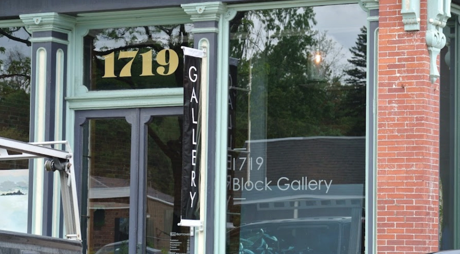 the outside of a vintage gallery in a small town.