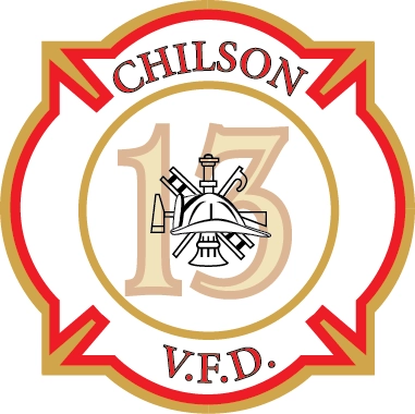 A white badge with red  & gold lettering and outline reading Chilson V.F.D. 13 with a helmet, ladder, ax and bell.