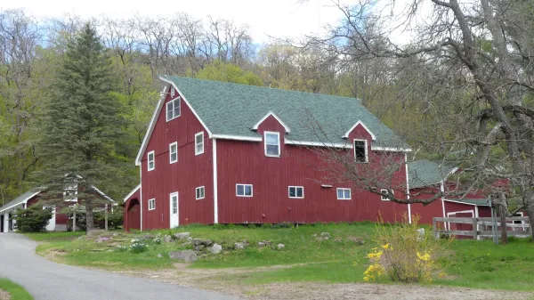 A red barn on the side of a cycling route.