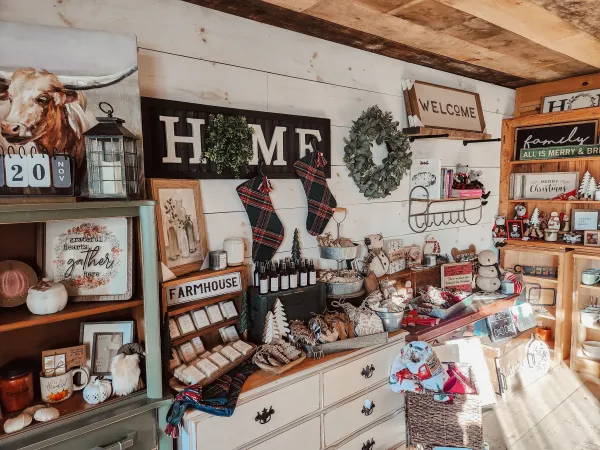 A shop decorated with quaint, country-themed Christmas decor and gifts.