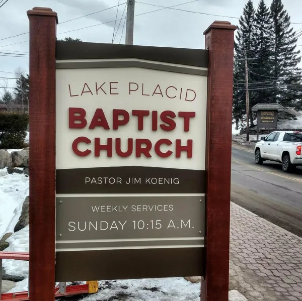 The brown sign with white background for the Lake Placid Baptist Church