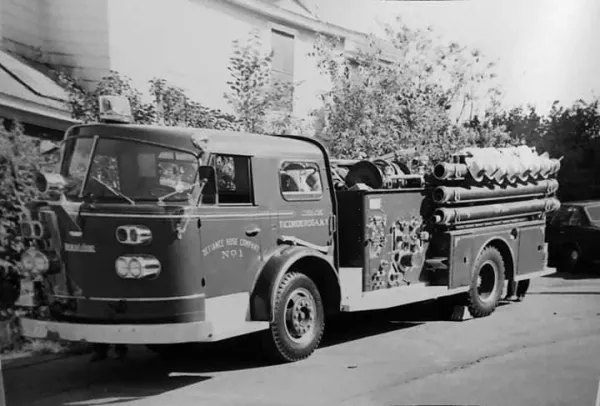 A black and white photo of an older fire truck.