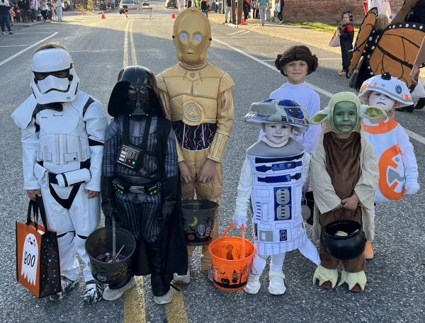 Seven children in Star Wars costumes at a Halloween event.