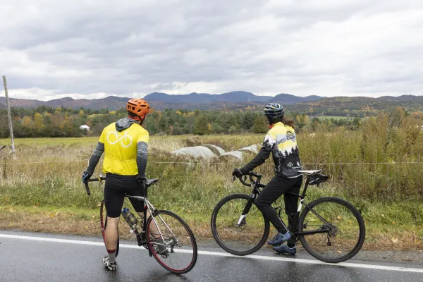 Two cyclists look at a farm field