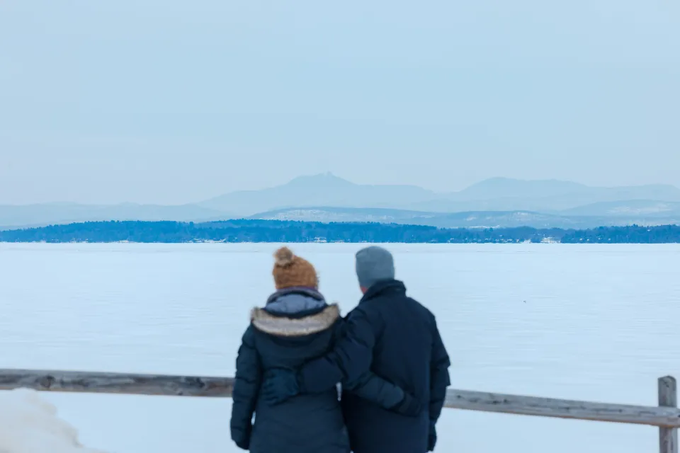 a couple looking out at the frozen lake